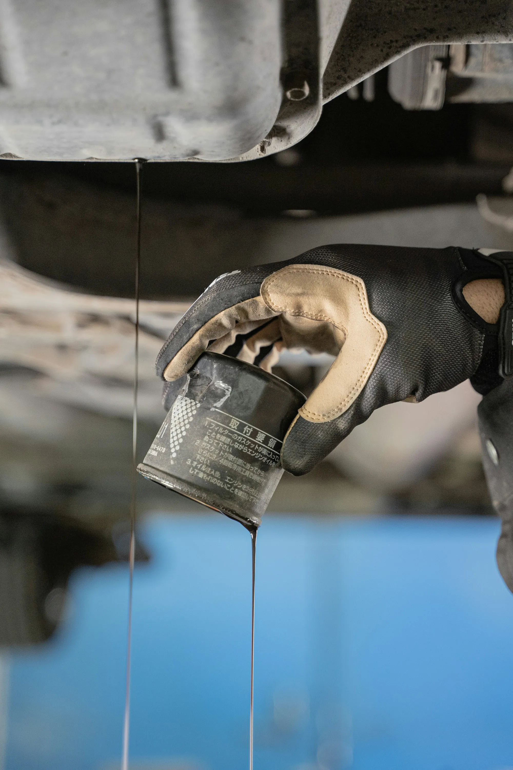 Oil draining from an engine during an oil change